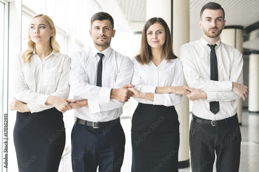 The four business people hold hands