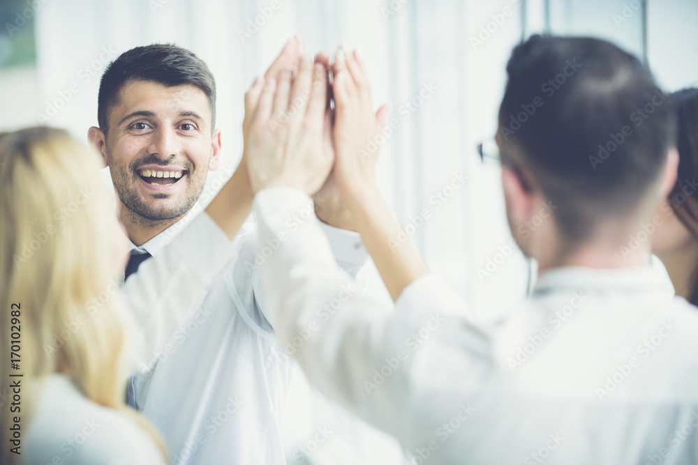 The happy people greeting with a high five The happy people greeting with a high five