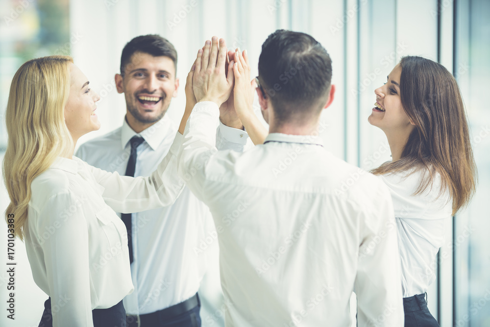 The happy business people greeting with a high five The happy business people greeting with a high five
