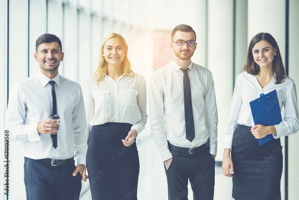 The business people walk in the office on the sunny background The business people walk in the office on the sunny background