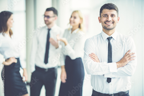 The smile businessman stand near partners
