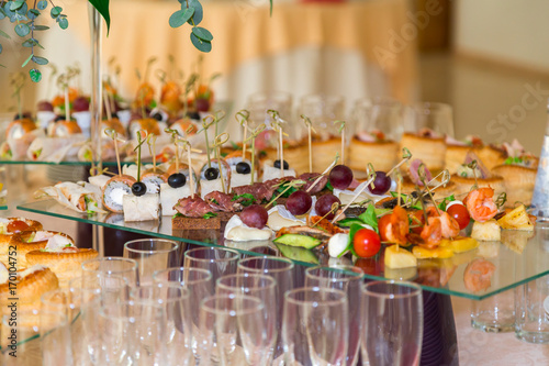 Delicacies and snacks at the Banquet. The buffet celebration. Restaurant catering. Table setting at the reception. photo