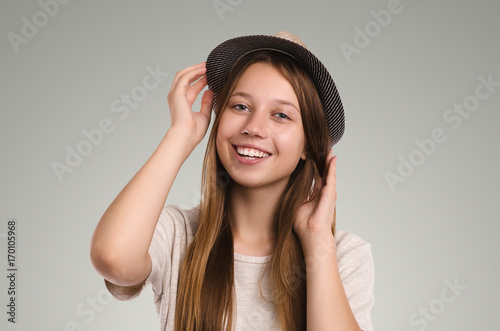 Positive casual woman posing. Emotional girl portrait. Young female with hat. The model is looking at the camera.