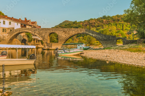 The old arched stone bridge of Crnojevica river on Montenegro.