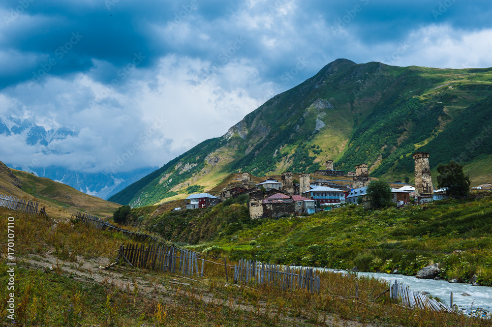 Fototapeta premium Village Ushguli landscape with massive rocky mountains Bezengi wall, Shkhara on the background in Svaneti, Georgia