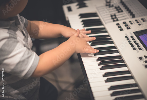 A boy is playing piano.