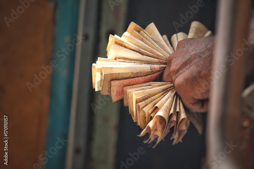 Closeup of Man holding bunch of currency notes in his hand photo