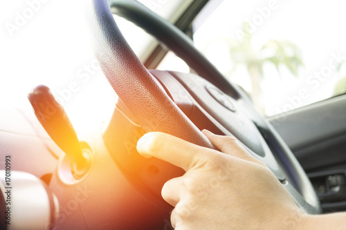 pastel orange light on blur man hand hold a steering wheel or drive car background