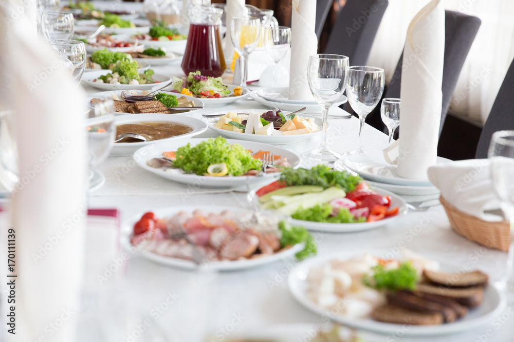 Wedding food table. A lot of tasty hearty food on the table Wedding food table. A lot of tasty hearty food on the table