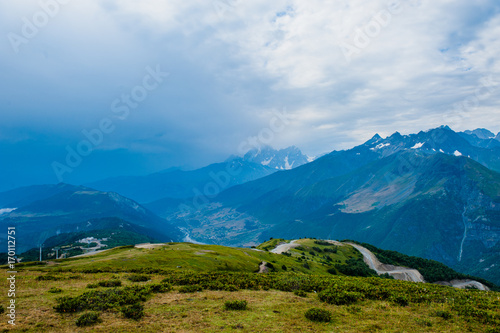 Mountain valley with snow peaks and clouds in Tetnuldi  Mestia  Georgia