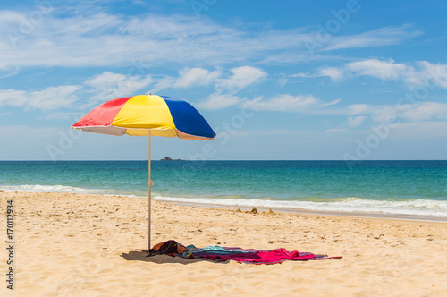 Colorful beach umbrella on the sandy beach on summer day. Naithon beach, Phuket, Thailand