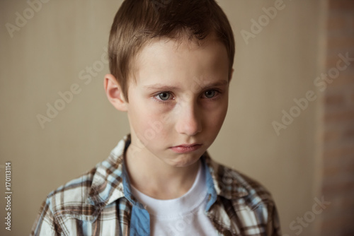 Teen boy sad, upset, ready to cry