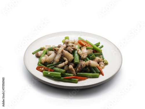 Streaky pork fried with spring onion flower and chili on white disk isolated on white background.clipping path included.