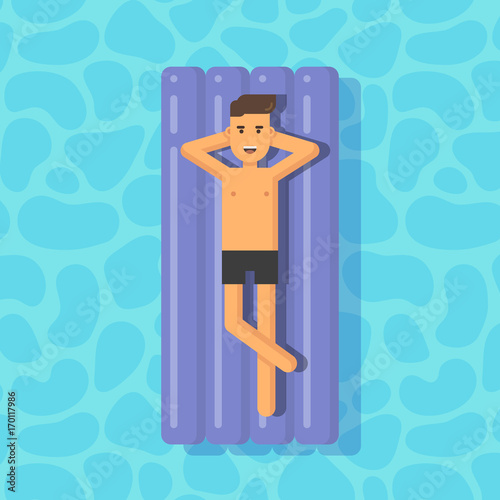 Young man floating on a mattress in a swimming pool
