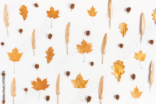 Autumn composition. Pattern made of autumn maple tree leaves and pine cones on white background. Flat lay, top view
