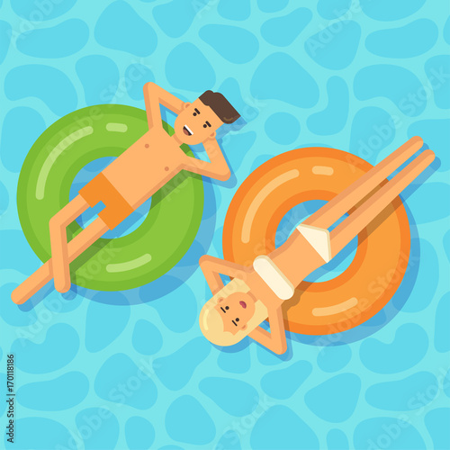 Man and woman floating on inflatable circles in a swimming pool