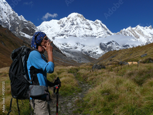 Man smoke pipe under the mountains - Beautiful day in Annapurna Base Camp