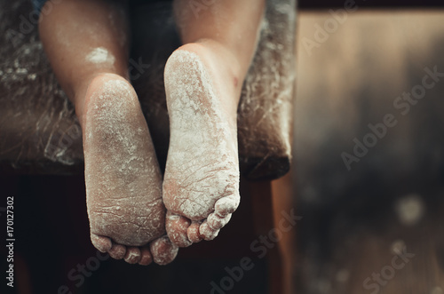 the legs of a small child in the flour very cute