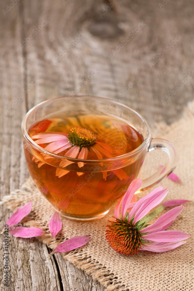 Cup of echinacea tea on old wooden table Cup of echinacea tea on old wooden table