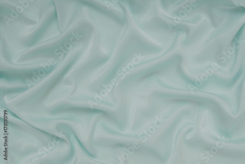 light turquoise satin material, blue sateen fabric, silk textile, beautiful creative background photo