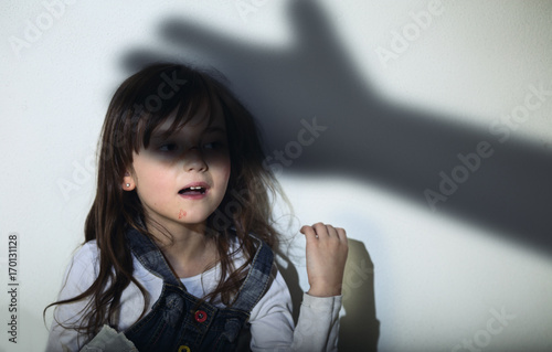 Violence in the family - frightened and sad girl photo