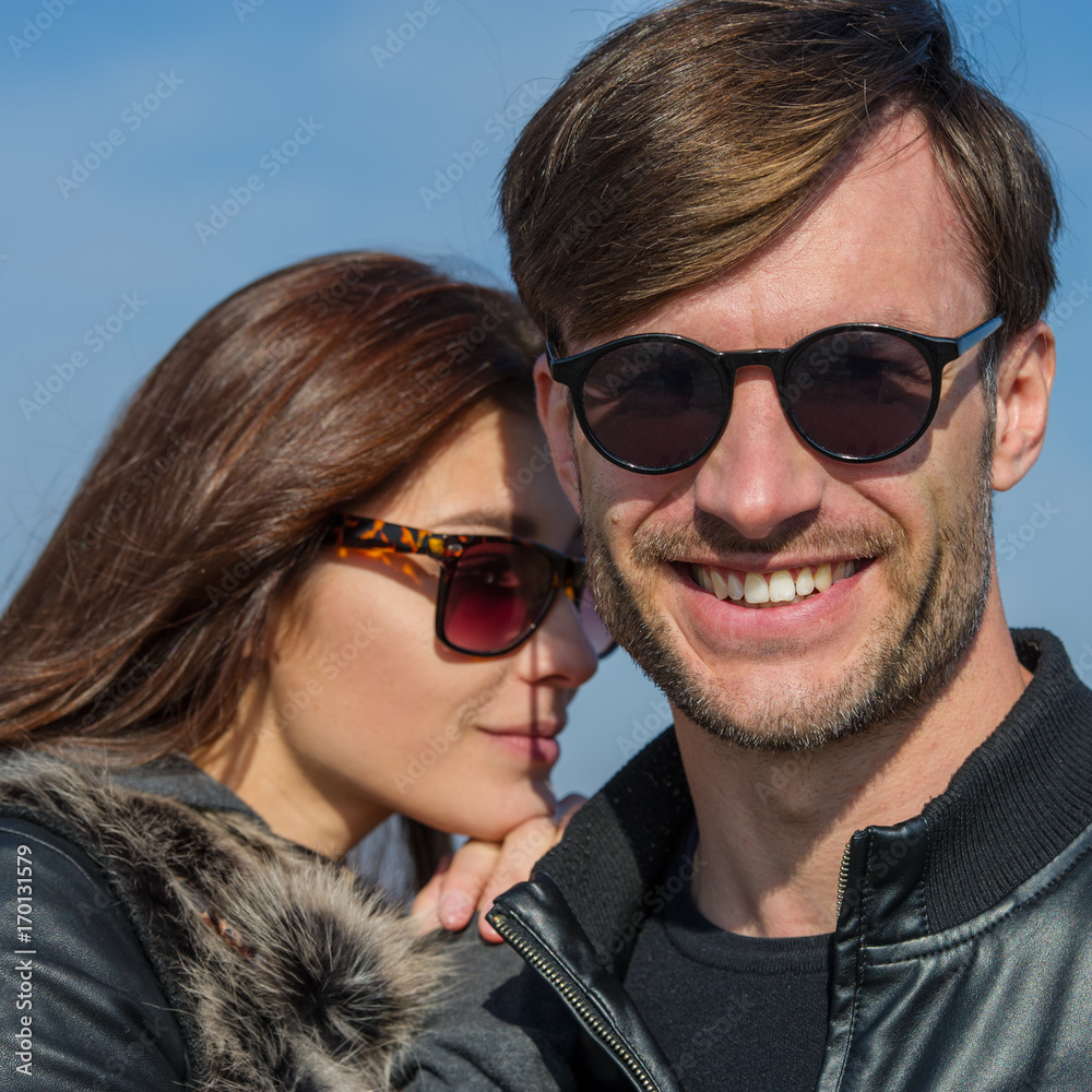 Obraz premium pair of lovers in sunglasses are laughing.