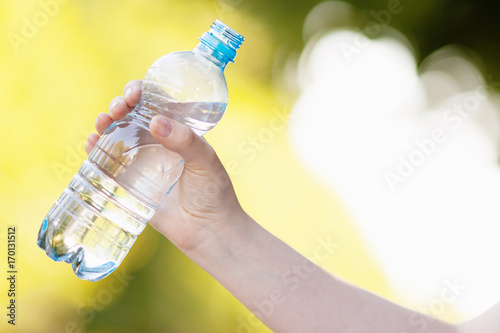 Hand holding fresh water bottle 