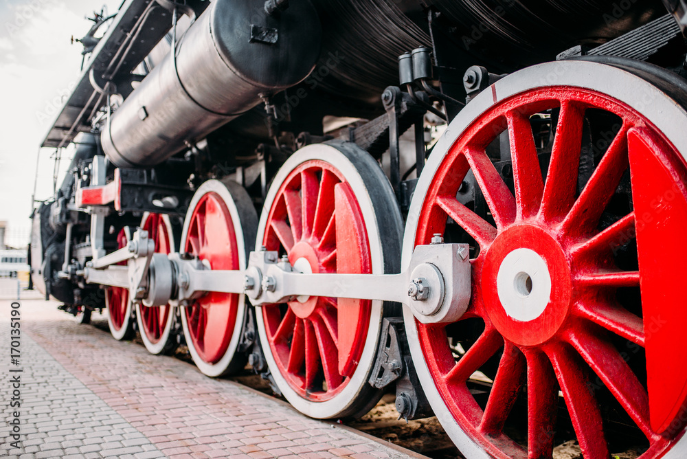 Old steam train, red wheels closeup