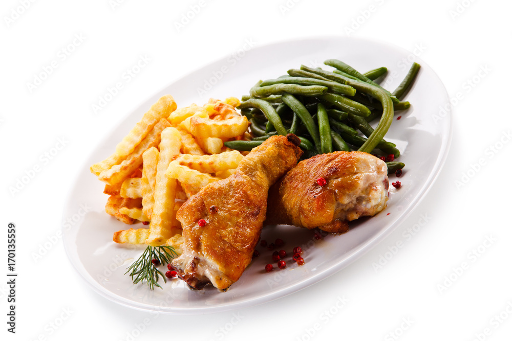 Grilled drumsticks with french fries and vegetables Grilled drumsticks with french fries and vegetables