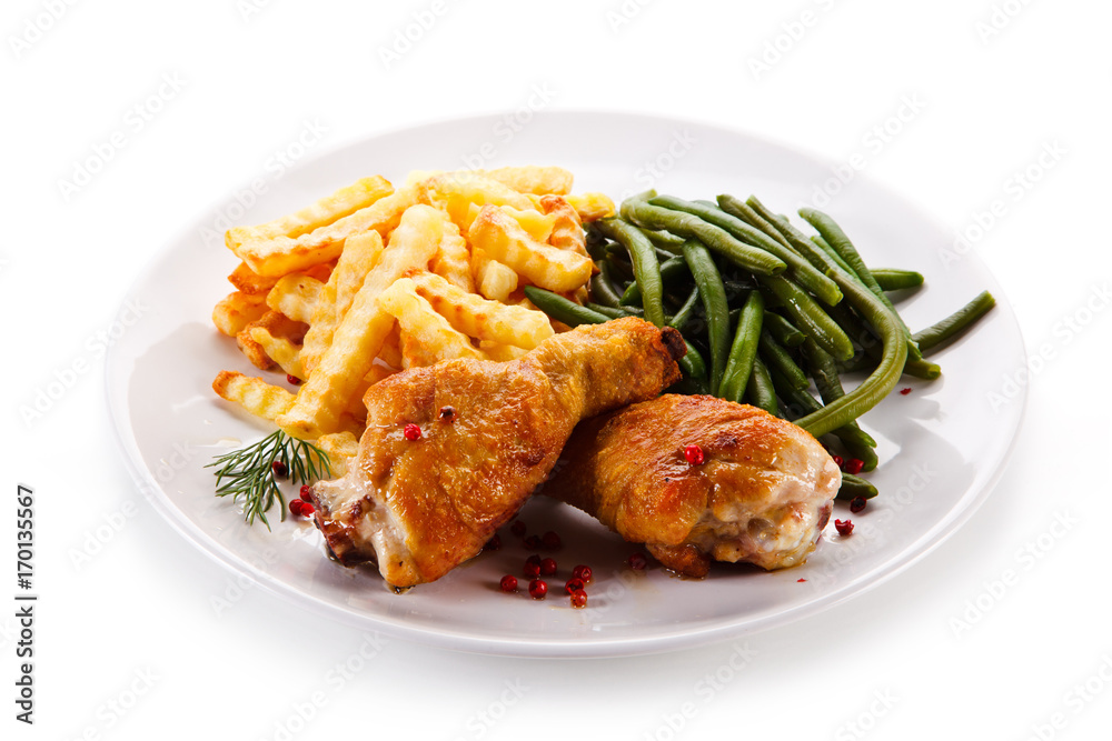 Grilled drumsticks with french fries and vegetables Grilled drumsticks with french fries and vegetables