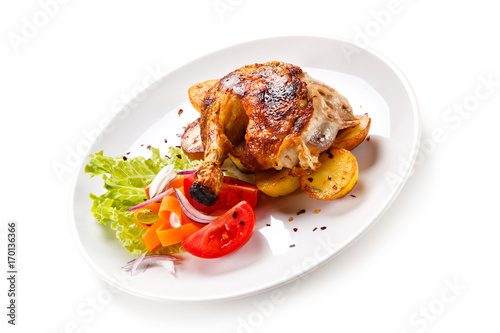 Roast chicken leg with chips on white background