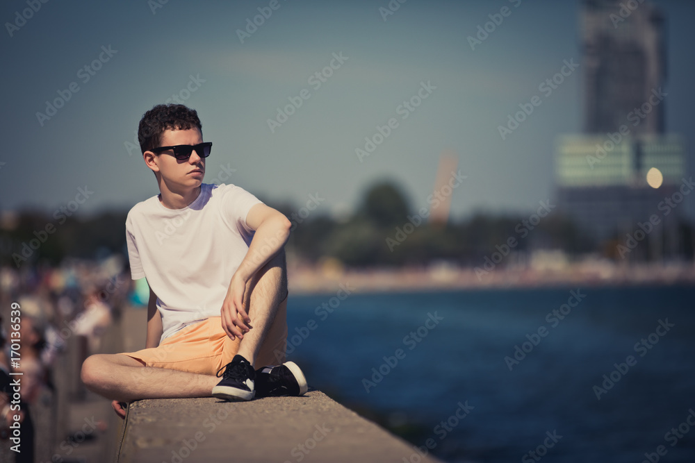 Young man relaxing on boulevar Young man relaxing on boulevar