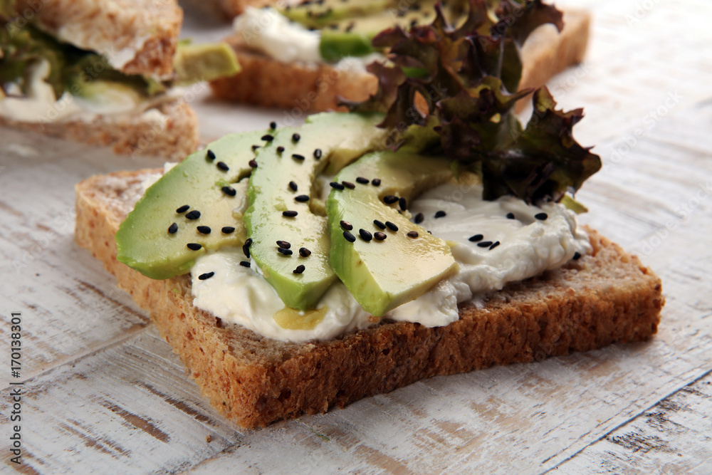 Sandwich with avocado and sesame - healthy breakfast concept Sandwich with avocado and sesame - healthy breakfast concept