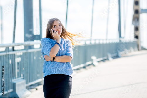 Beautiful happy young businesswoman using cell phone on city street. Free Download Beautiful happy young businesswoman using cell phone on city street. - GFXLoad