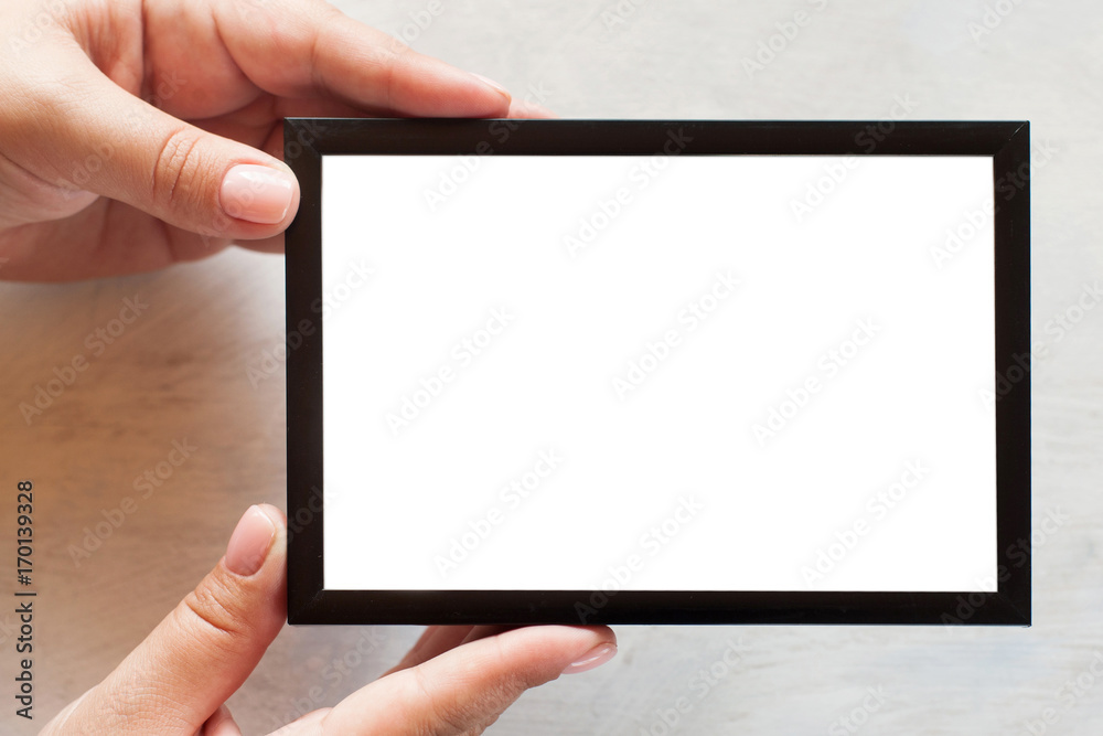 Blank photo frame holding in hand on white background. Menu, recipes, greetings and memories concept, picture with copy space Blank photo frame holding in hand on white background. Menu, recipes, greetings and memories concept, picture with copy space
