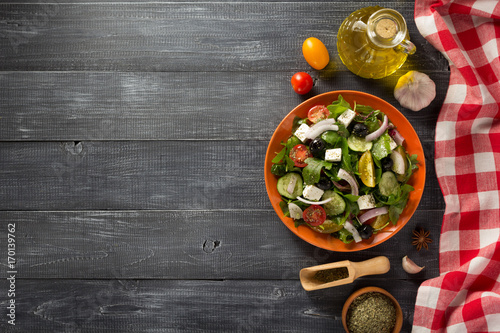fresh greek salad in plate and ingredients