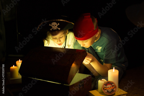 Childhood dreams. Cute girl and adventurous boy found a treasures. Happy young pirates.