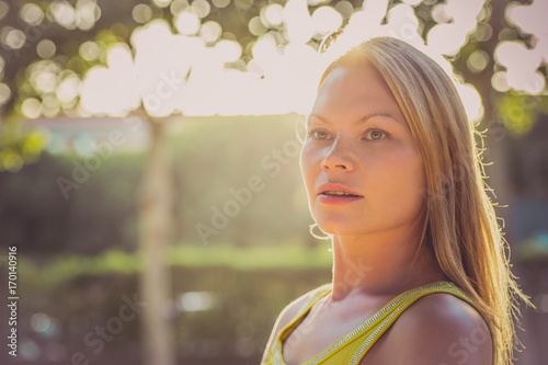  Beauty woman outdoors enjoying nature. Hot summer day. Sunshine girl portrait.