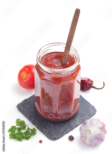 tomato sauce in glass jar on white