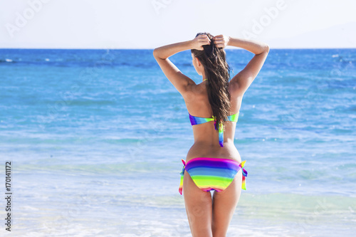 Woman in bikini walking to sea © yellowj