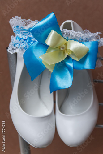 Bridal accessories on a white chair with flowers, photo