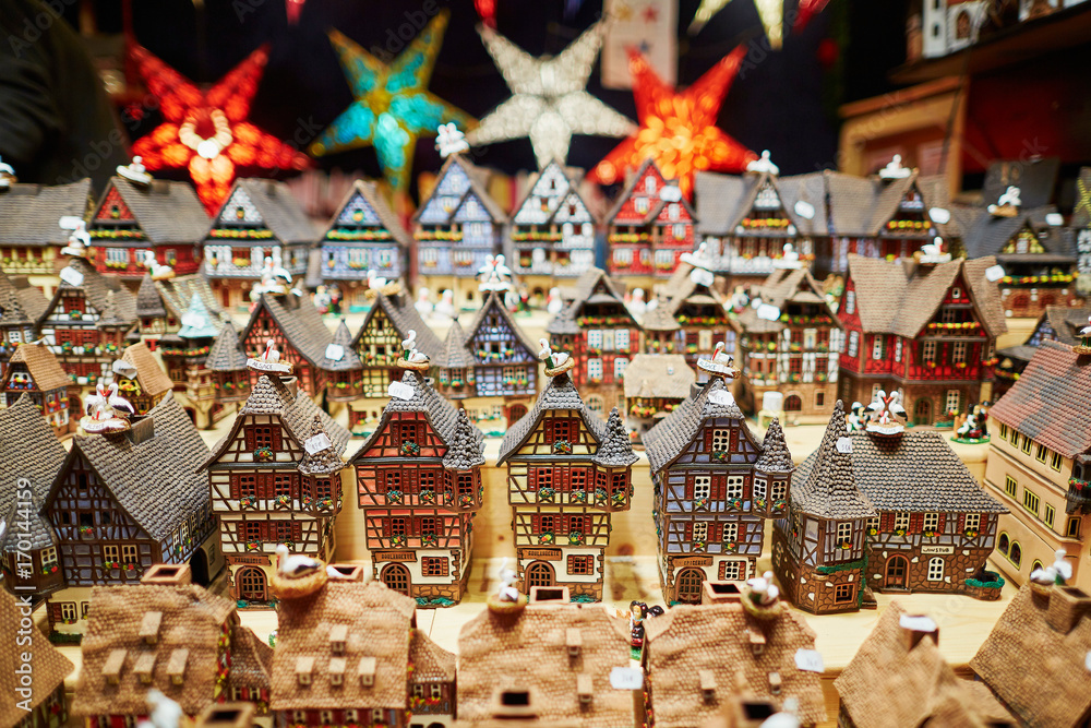 Variety of ceramic houses and star garlands at traditional Christmas market in Strasbourg Variety of ceramic houses and star garlands at traditional Christmas market in Strasbourg
