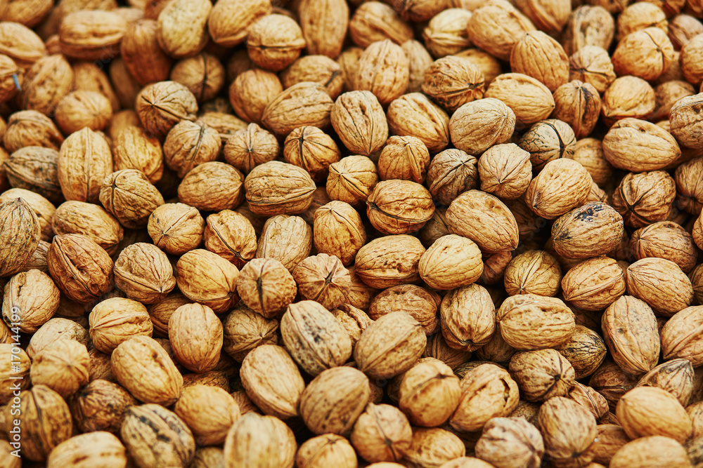 Large heap of walnuts on market Large heap of walnuts on market