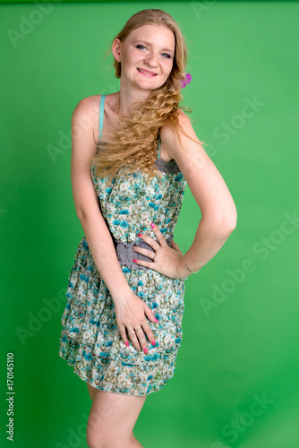 Beautiful romantic girl blonde in summer dress with orchid flower
