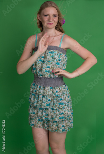 Beautiful romantic girl blonde in summer dress with orchid flower

