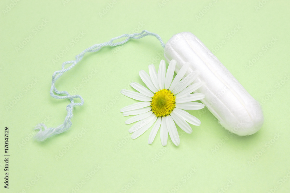 Medicinal chamomile flower and menstrual sanitary tampon. Woman critical  days, gynecological menstruation cycle. Menstruation sanitary woman hygiene  for blood period. Medical conceptual photo. Stock Photo | Adobe Stock