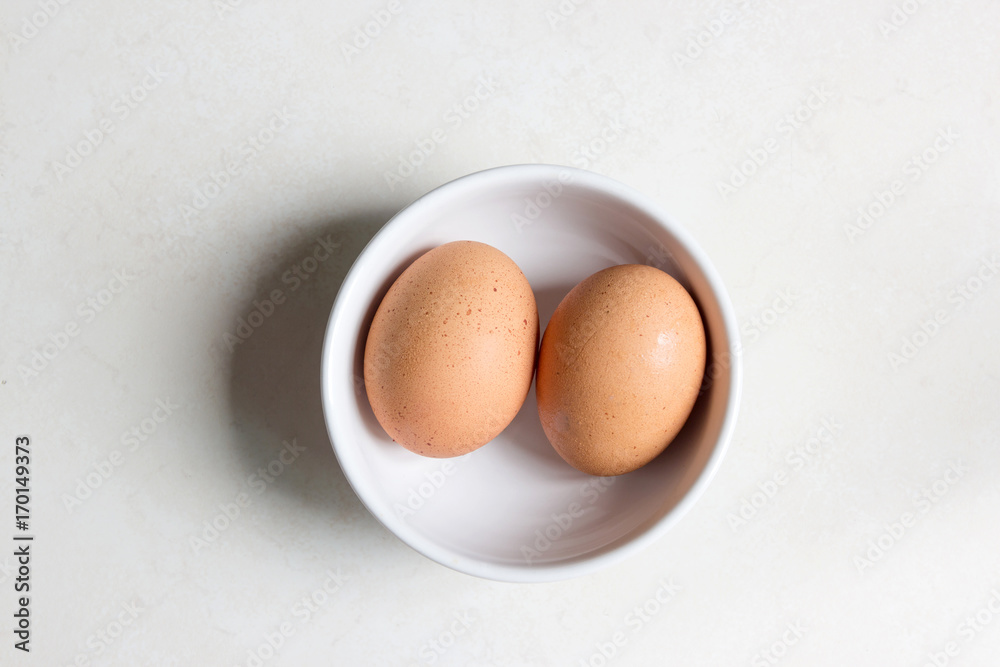 raw eggs in white bowl