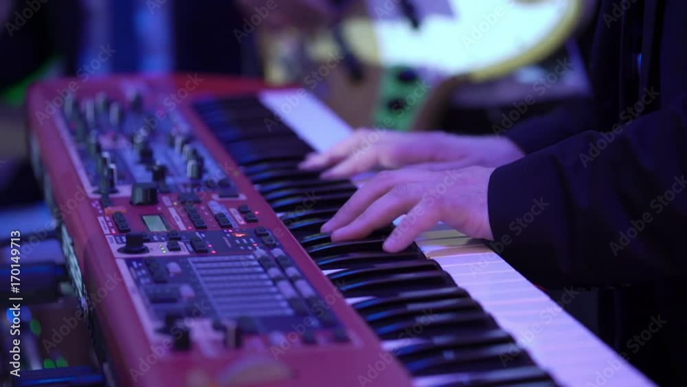Man playing music on piano keyboard Man playing music on piano keyboard