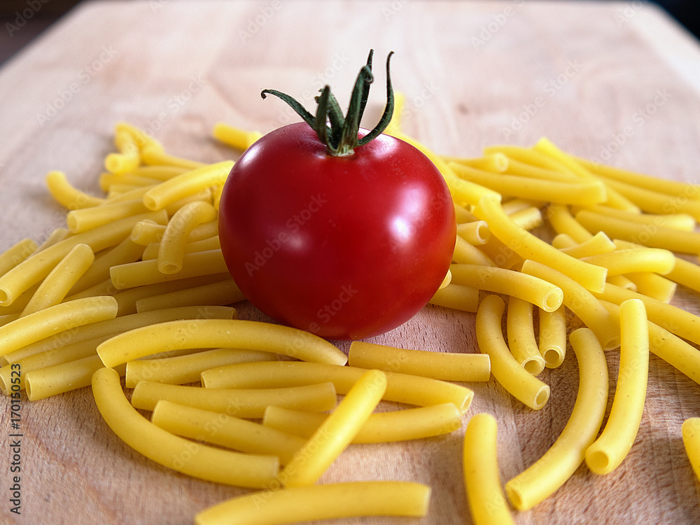 Tomato with pasta on woodplate
