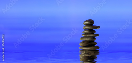 Photography Zen stones stack on blue background